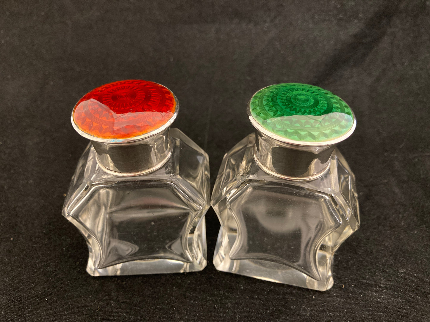 A pair of antique silver and enamel topped perfume bottles