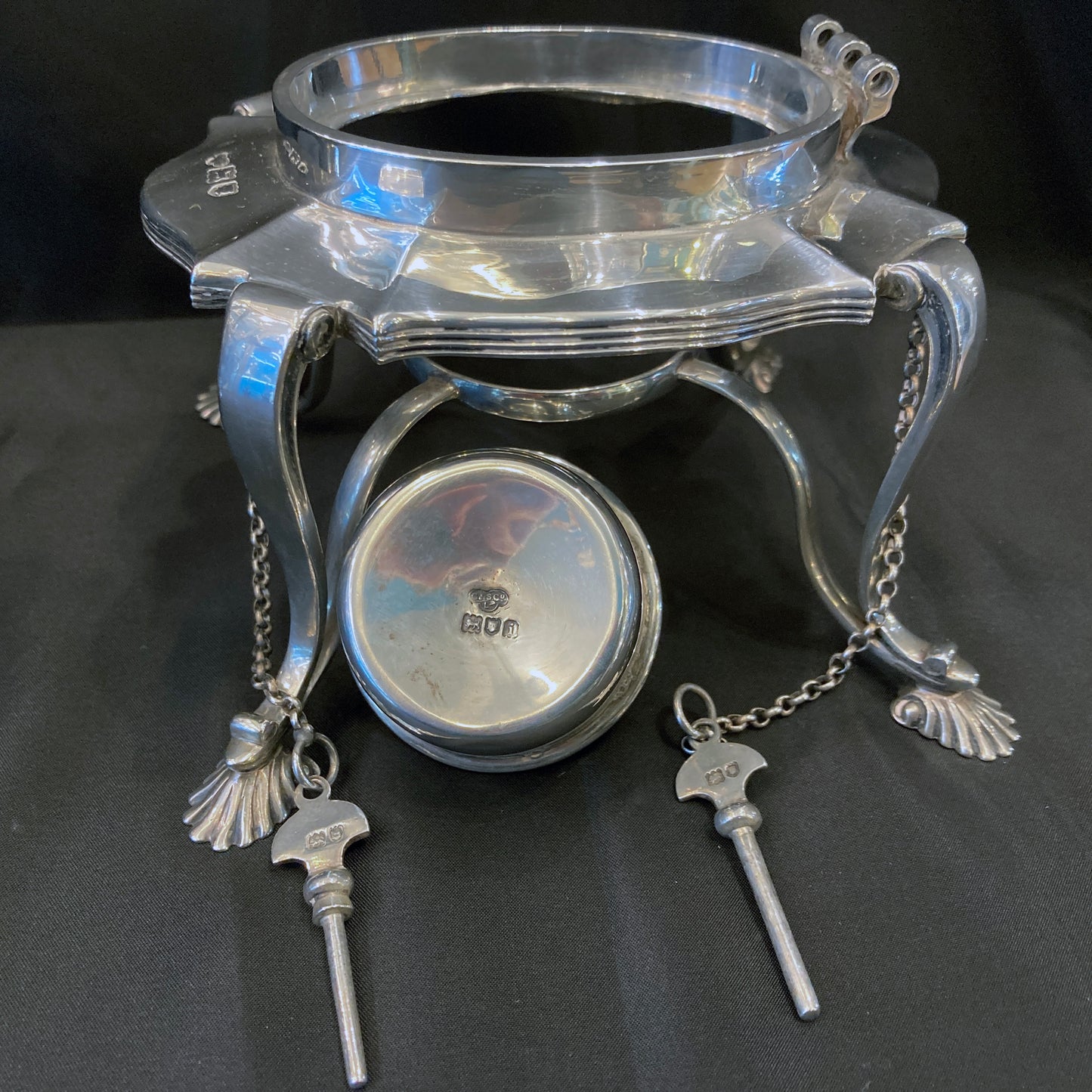 Silver kettle on stand by Goldsmiths and Silversmiths