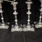 A set of silver candelabra with matching candle sticks.