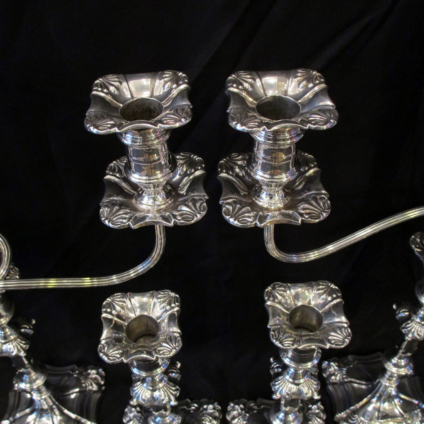 A set of silver candelabra with matching candle sticks.