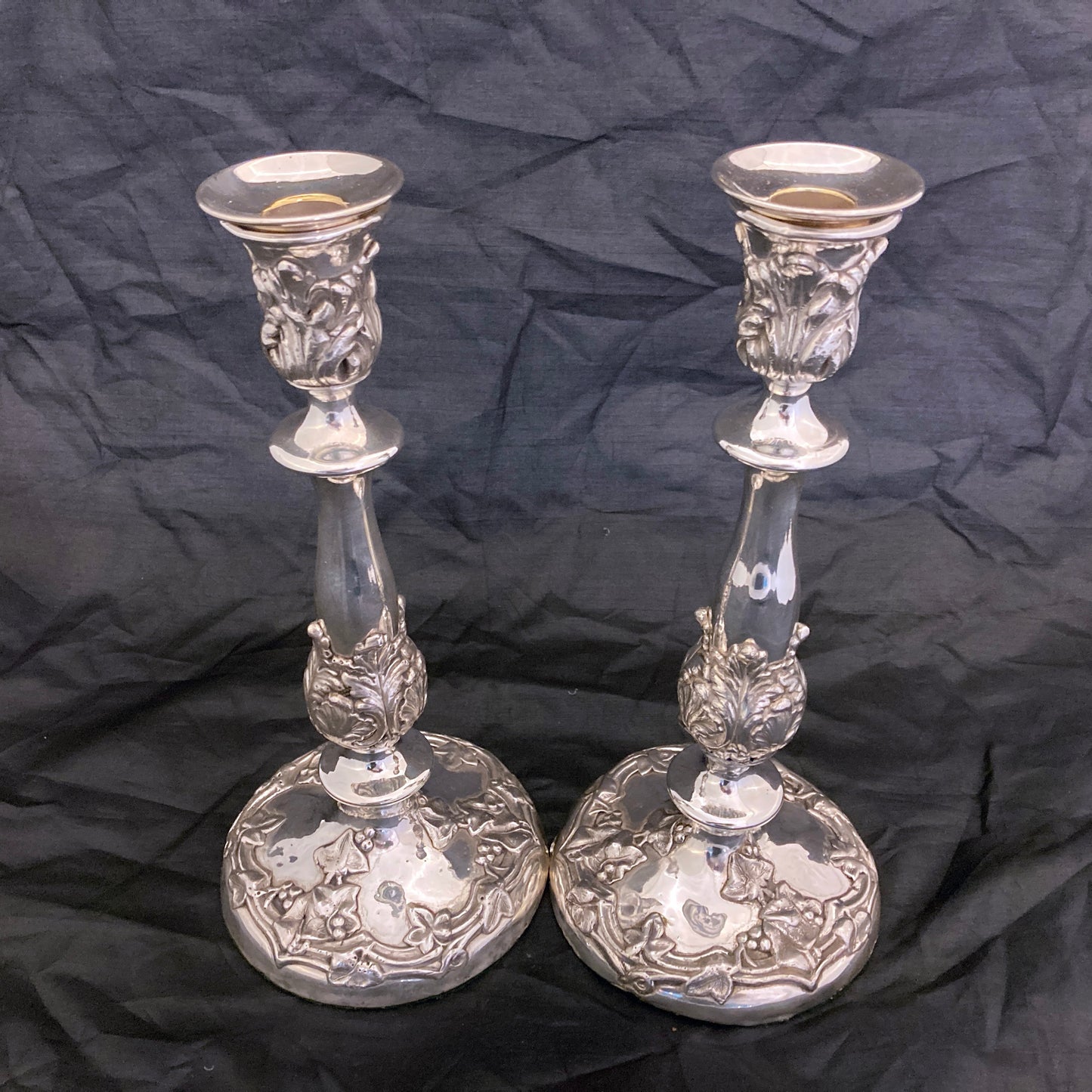 A pair of antique silver plated candlesticks