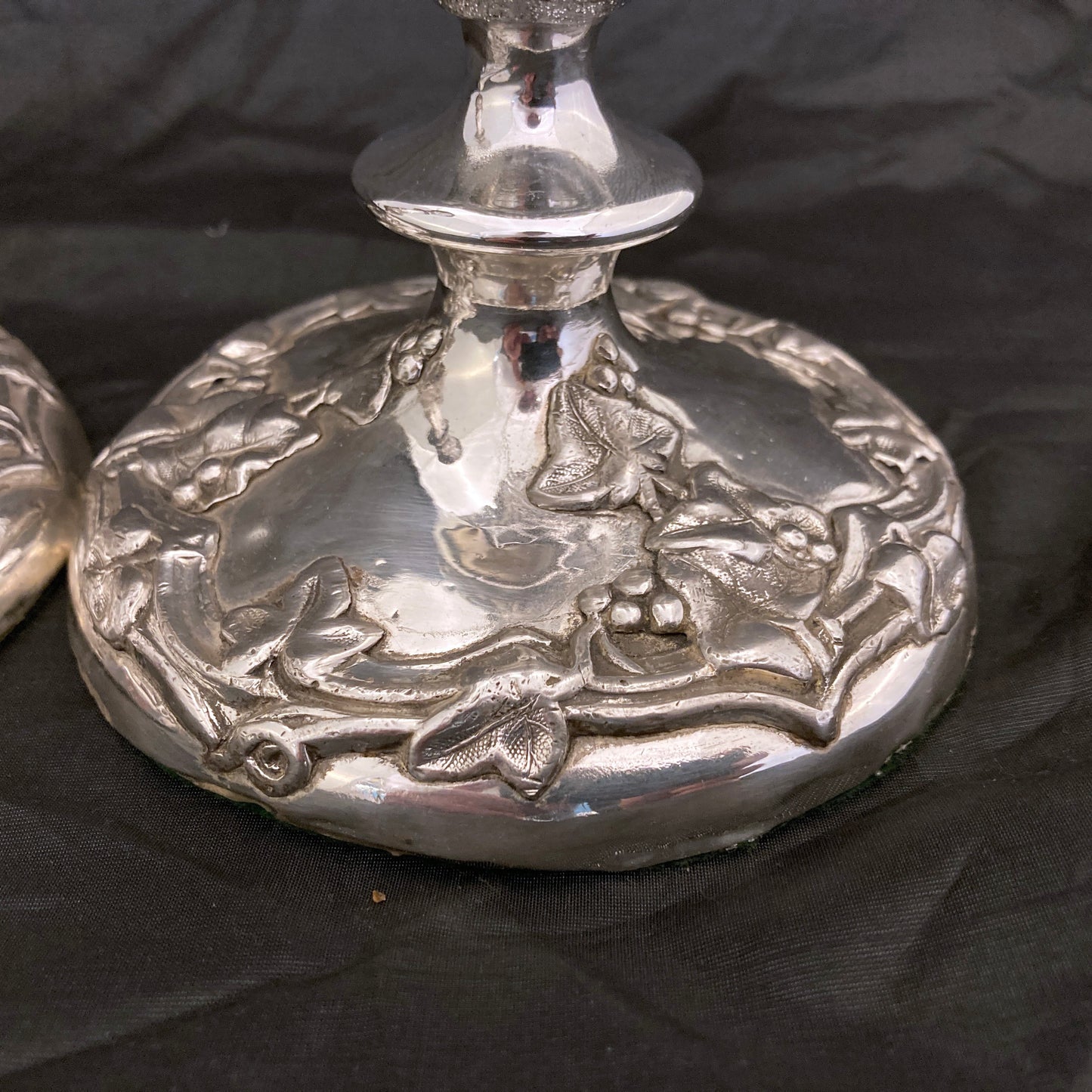 A pair of antique silver plated candlesticks