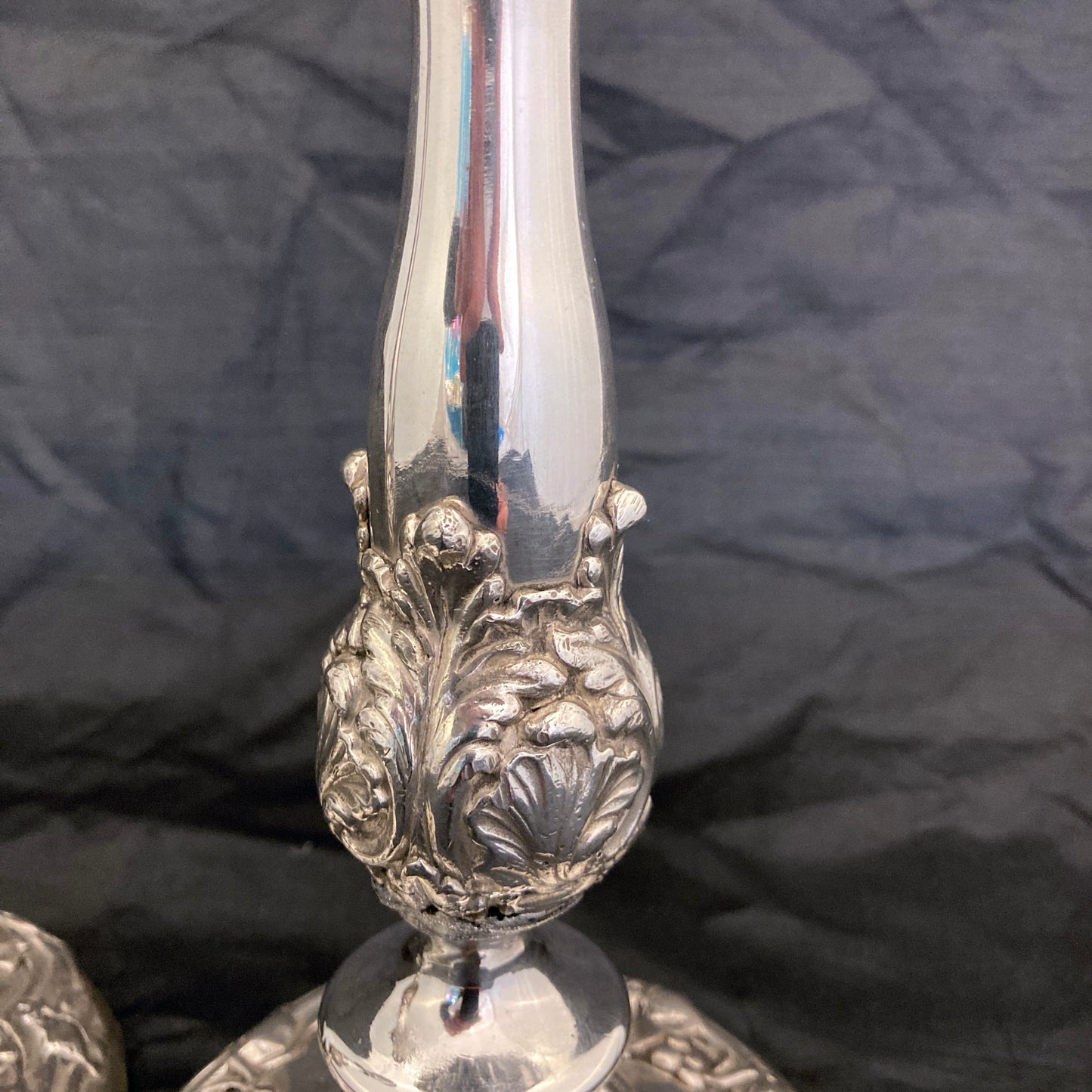 A pair of antique silver plated candlesticks