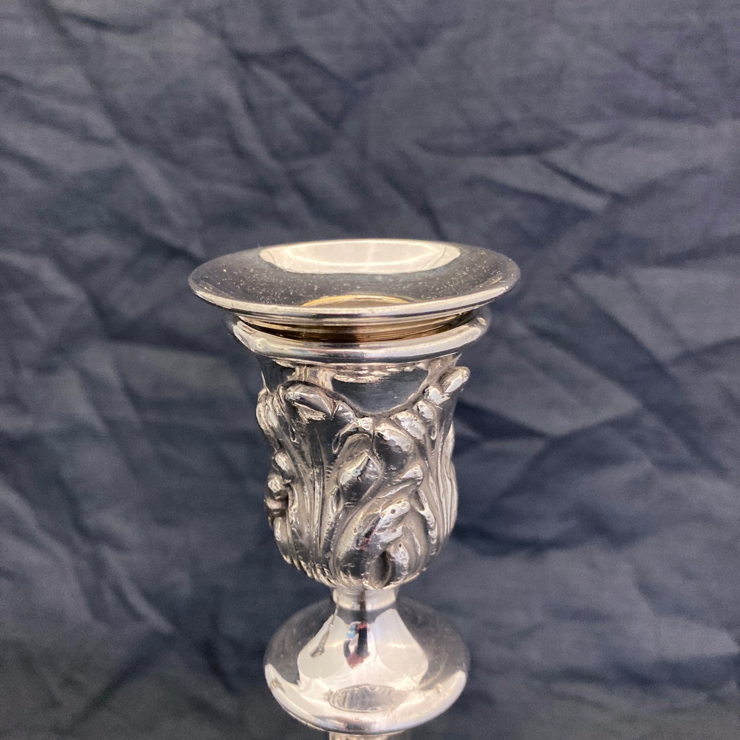 A pair of antique silver plated candlesticks