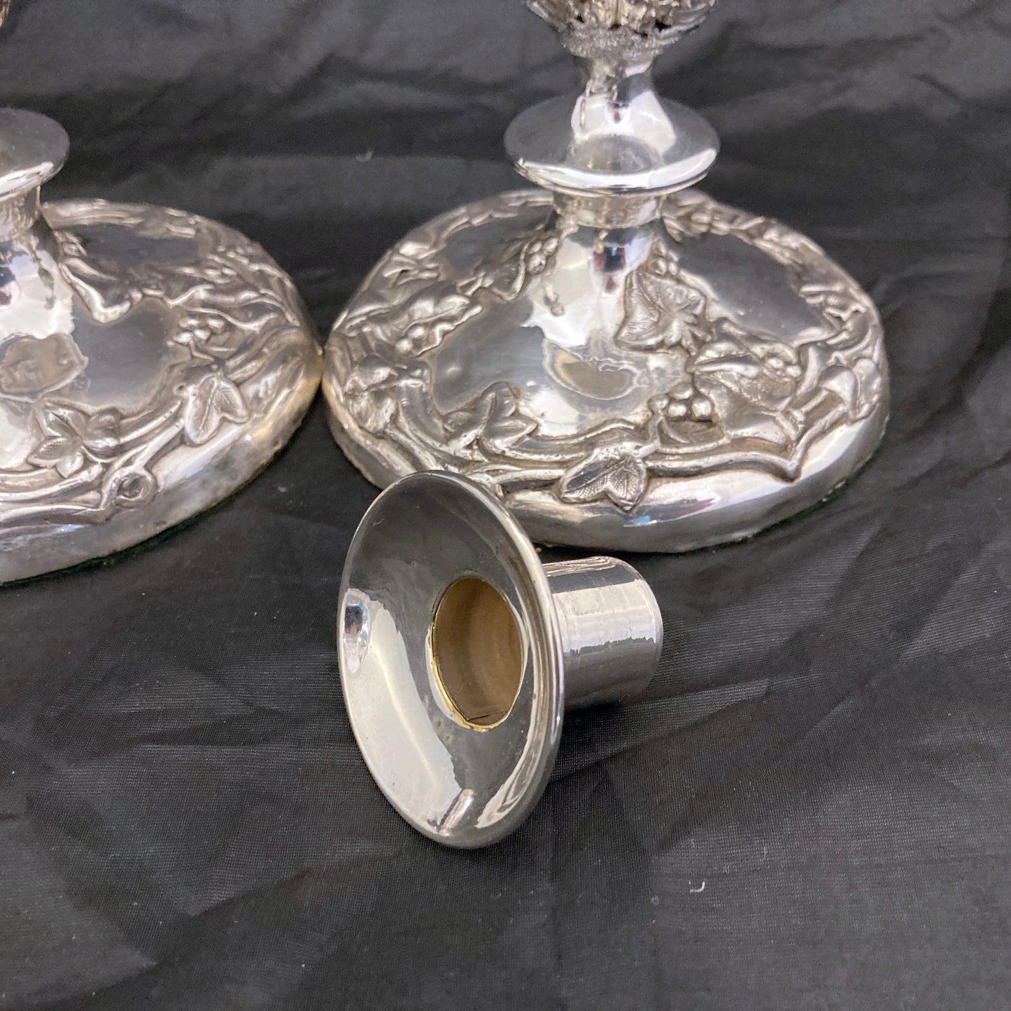 A pair of antique silver plated candlesticks