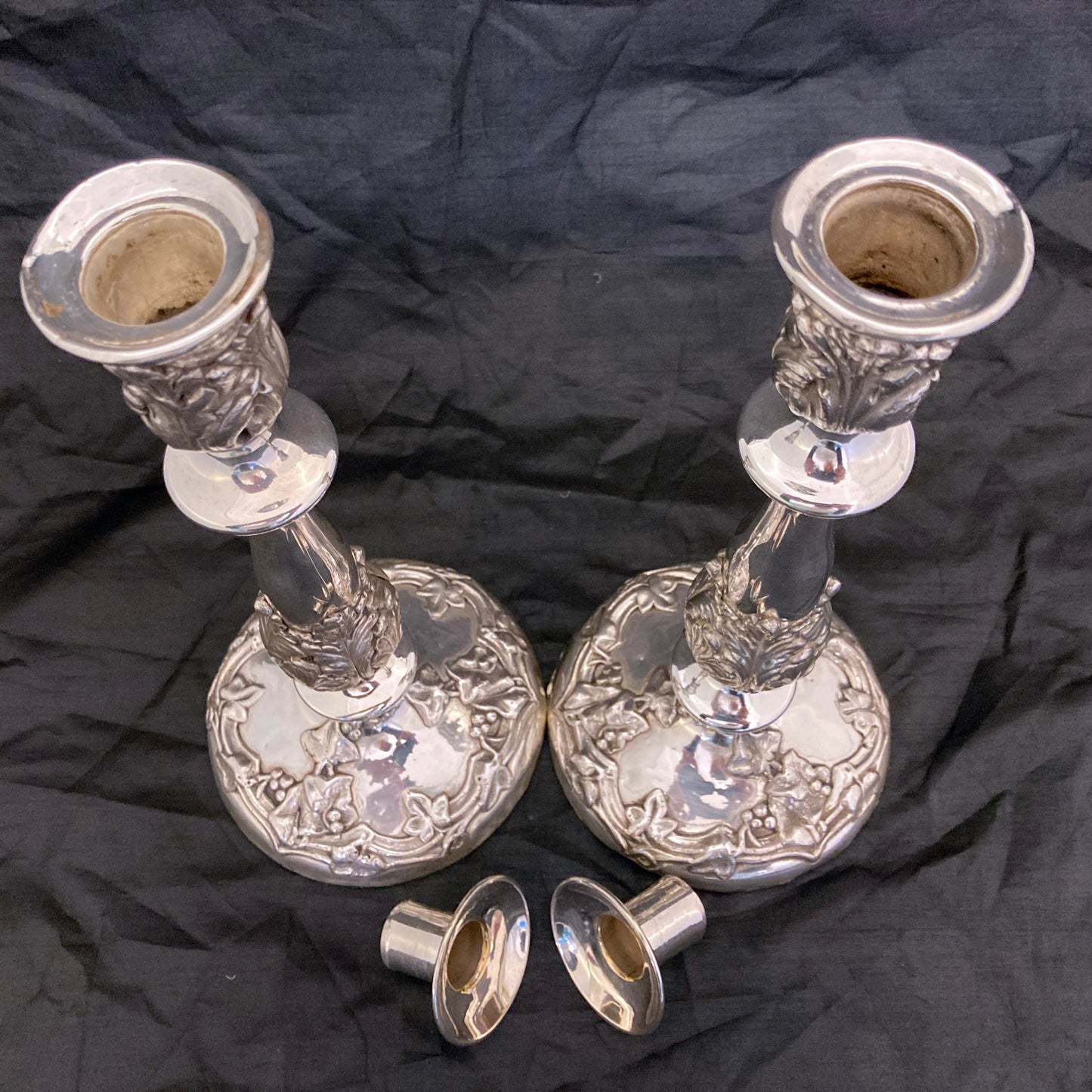 A pair of antique silver plated candlesticks