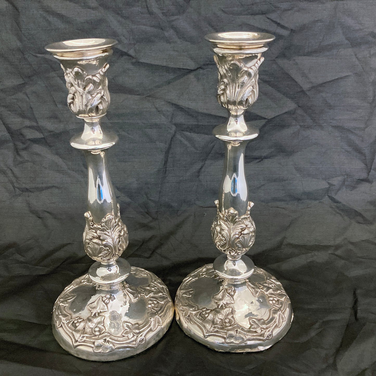 A pair of antique silver plated candlesticks