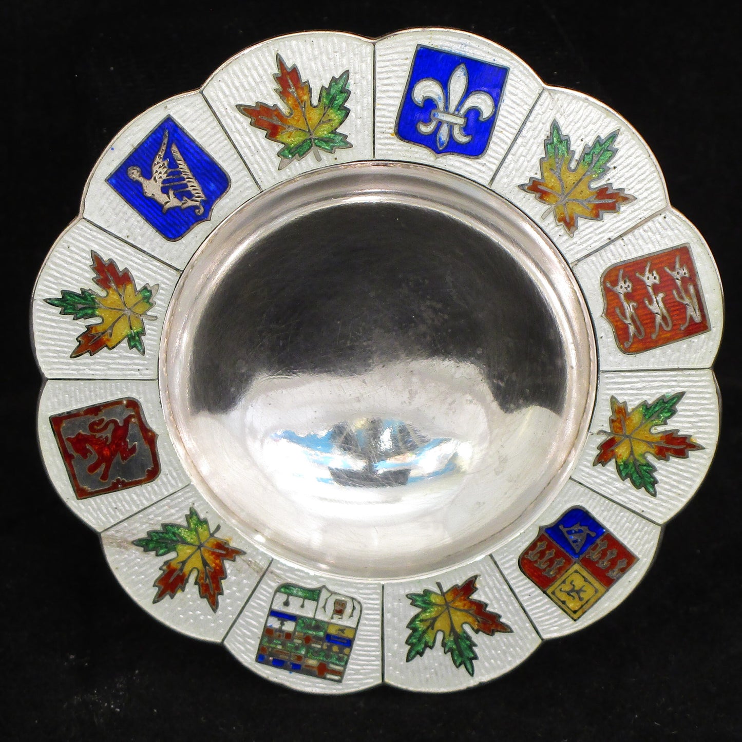 A silver and enamel ring tray.