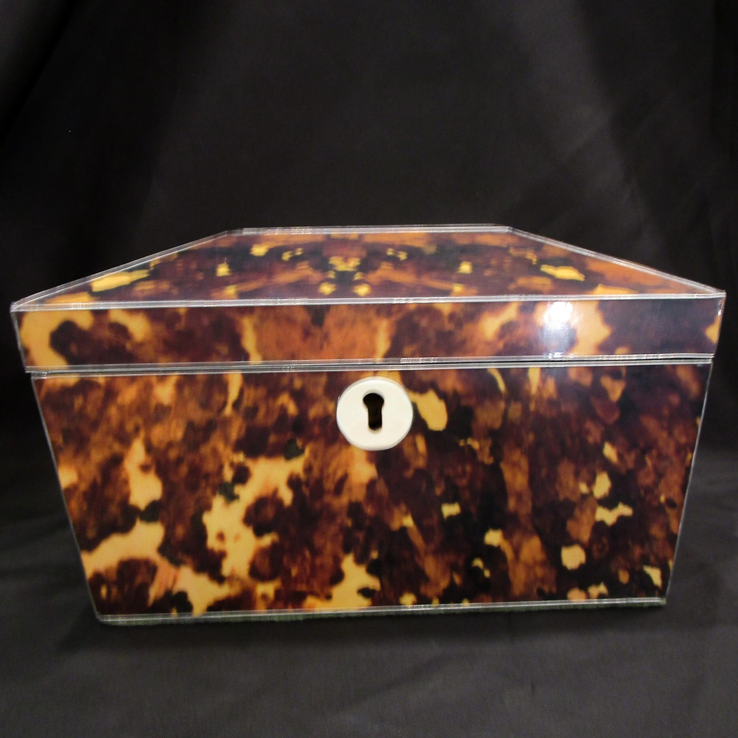 A faux tortoise shell tea caddy