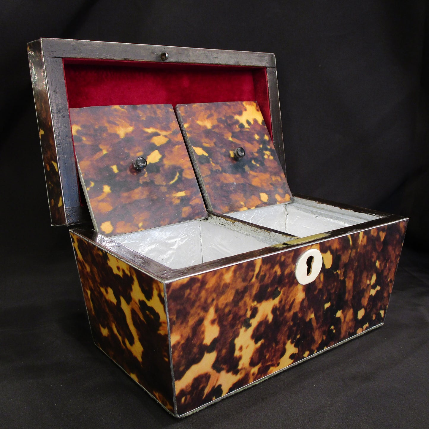 A faux tortoise shell tea caddy
