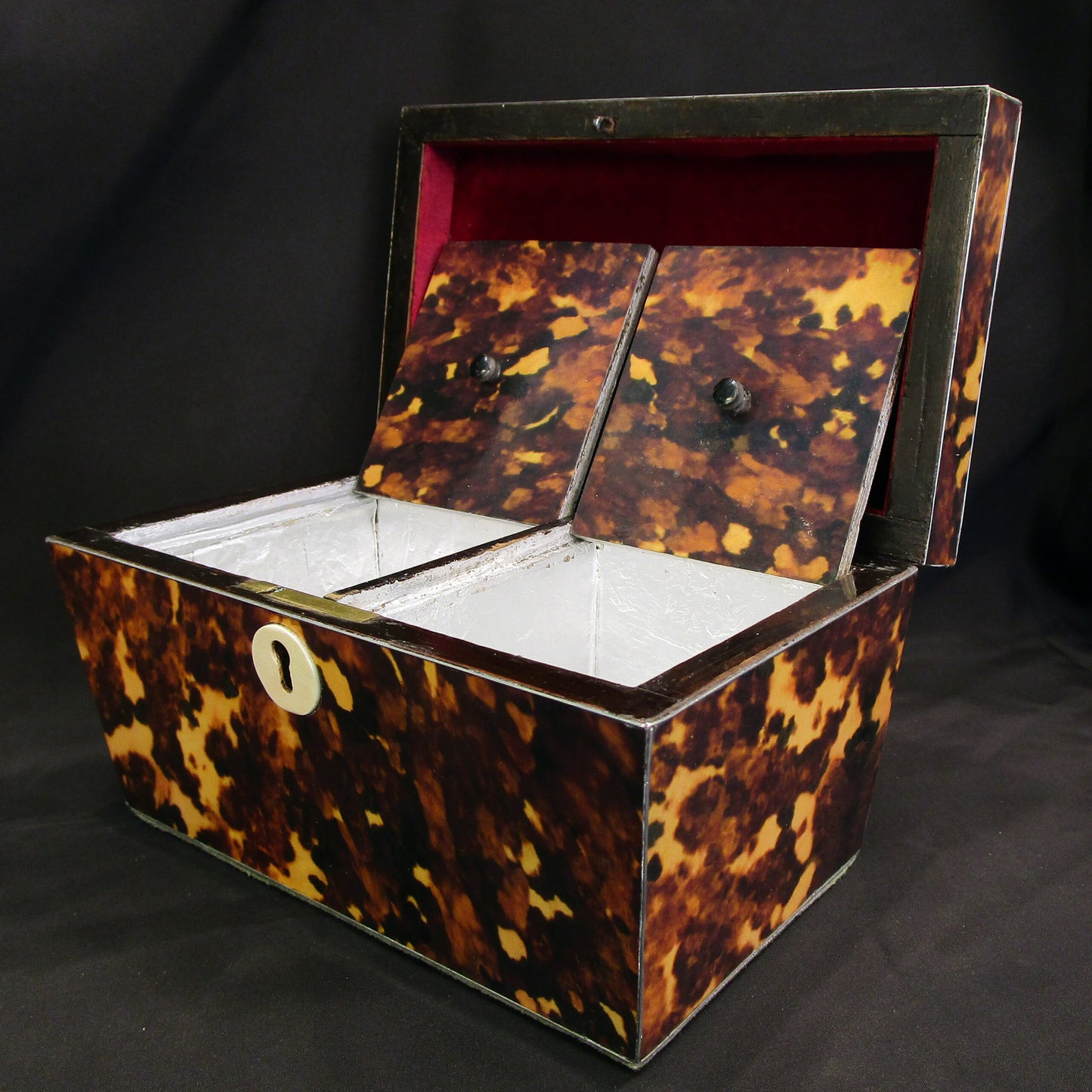 A faux tortoise shell tea caddy