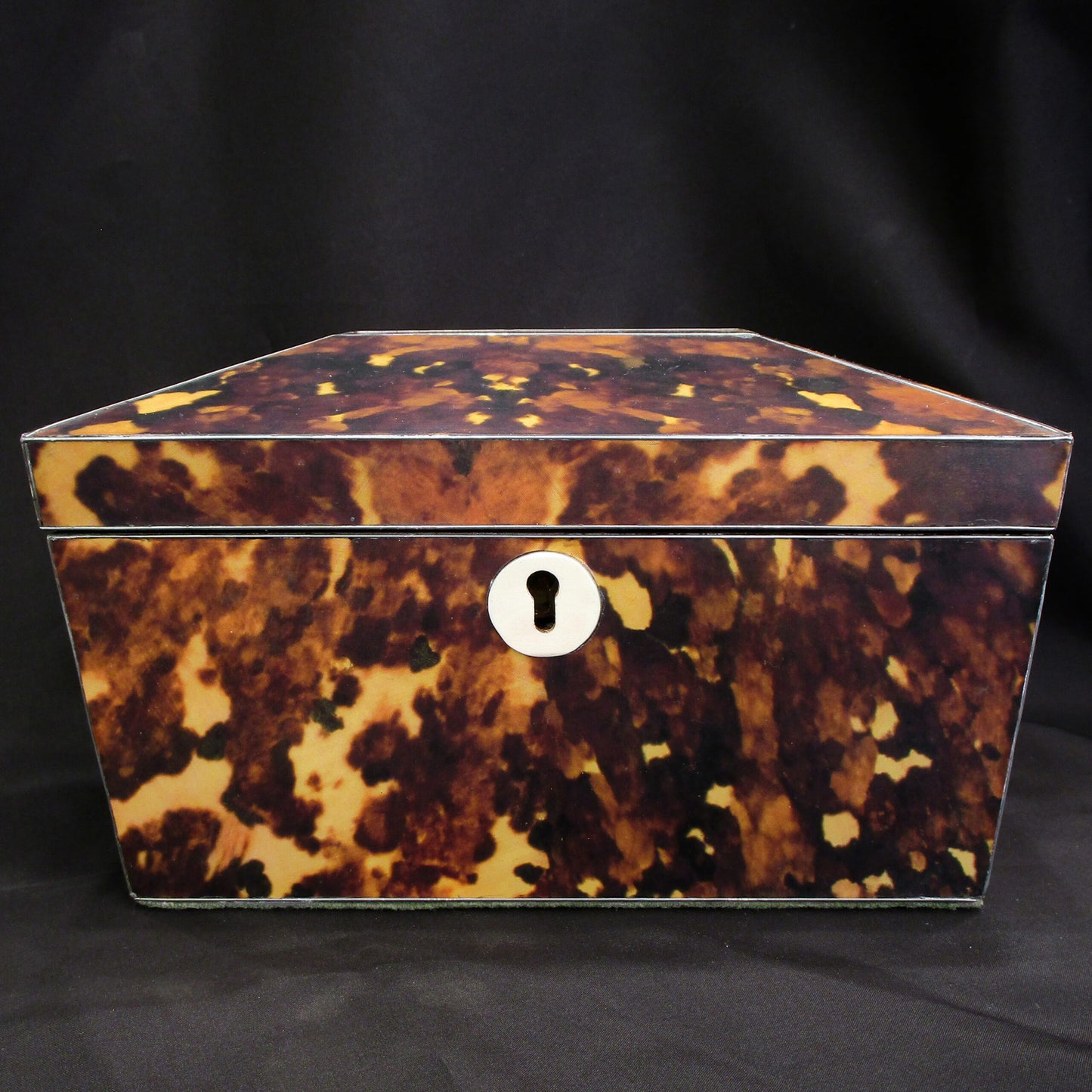 A faux tortoise shell tea caddy