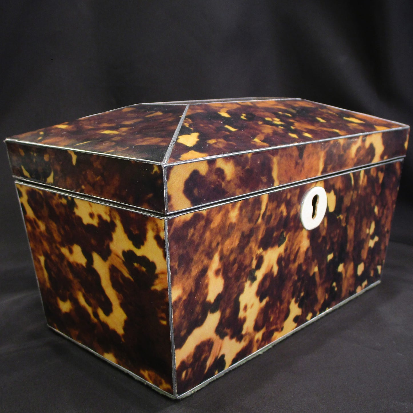 A faux tortoise shell tea caddy
