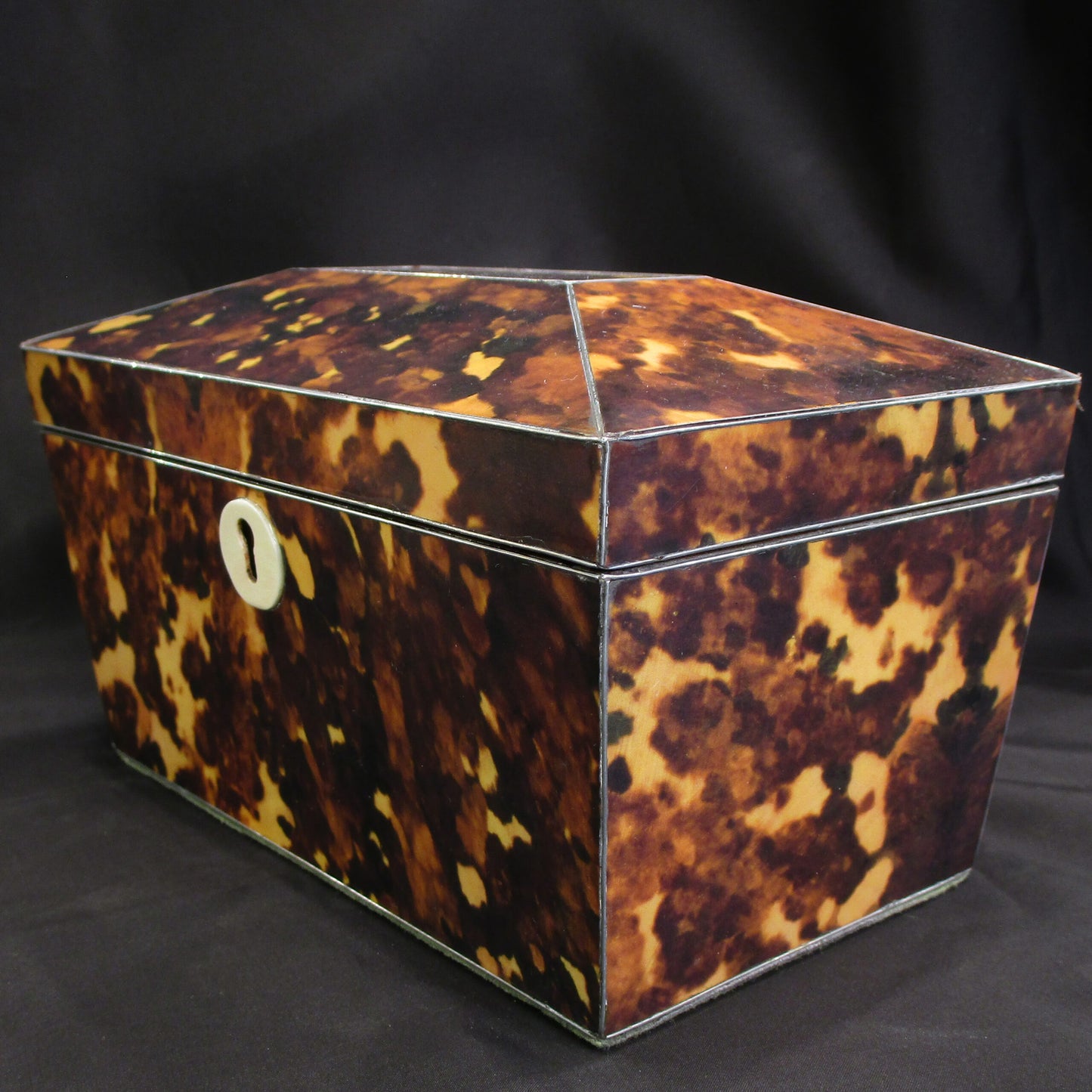A faux tortoise shell tea caddy