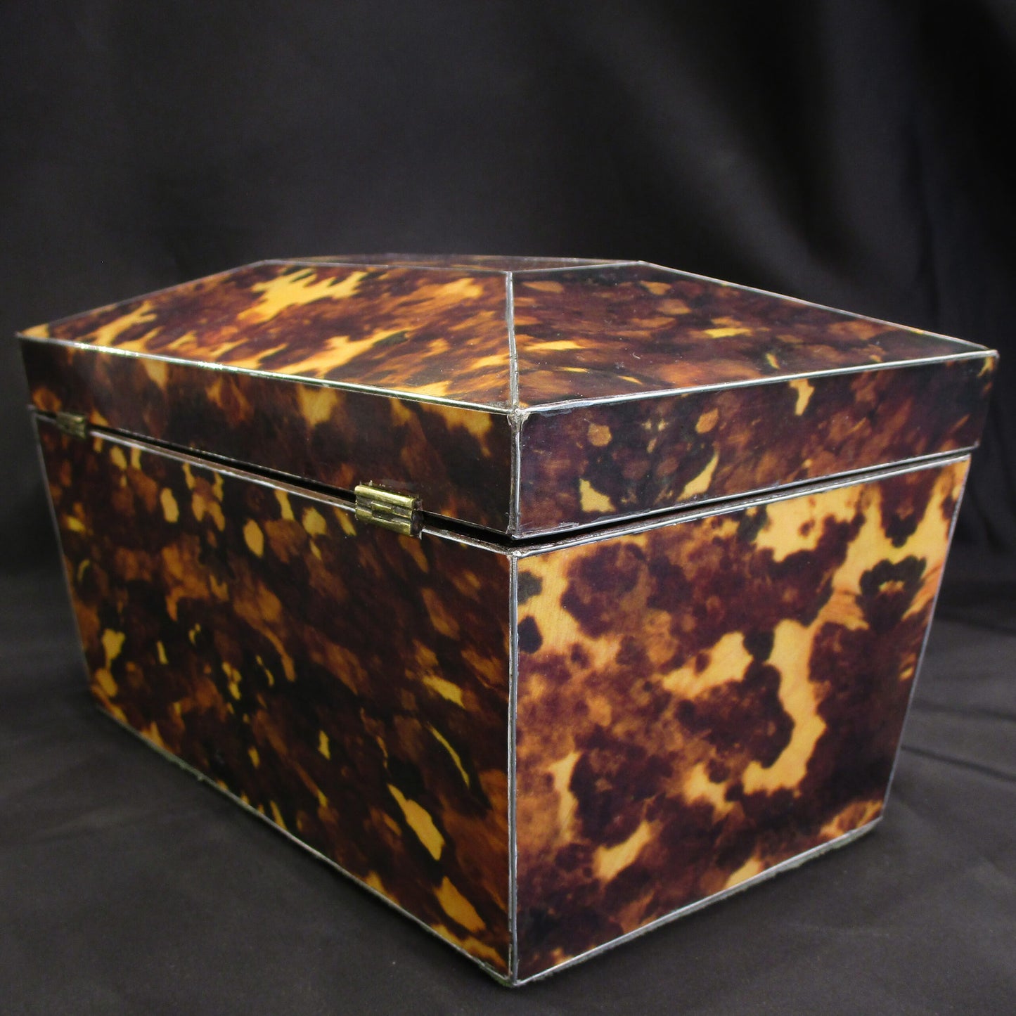 A faux tortoise shell tea caddy