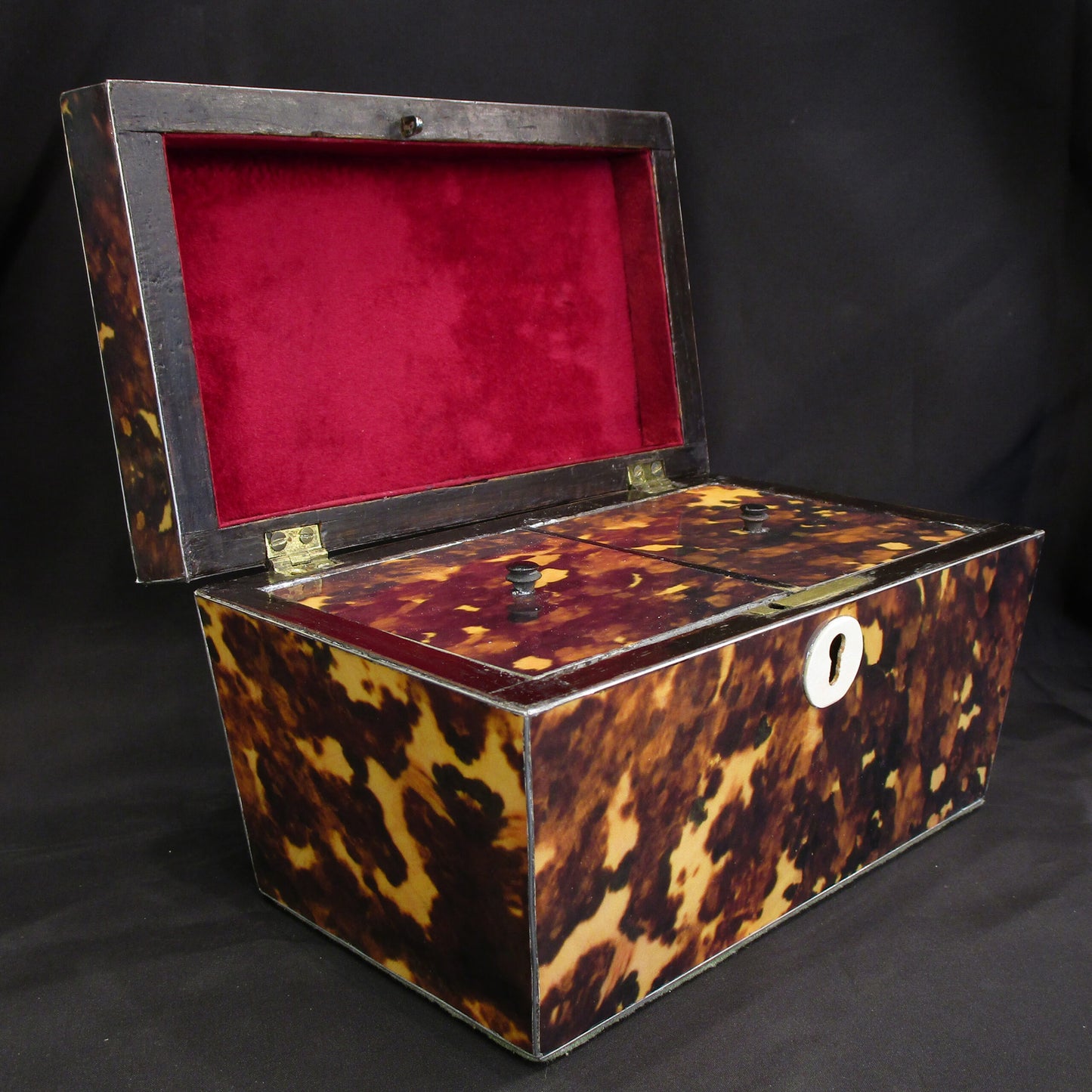 A faux tortoise shell tea caddy