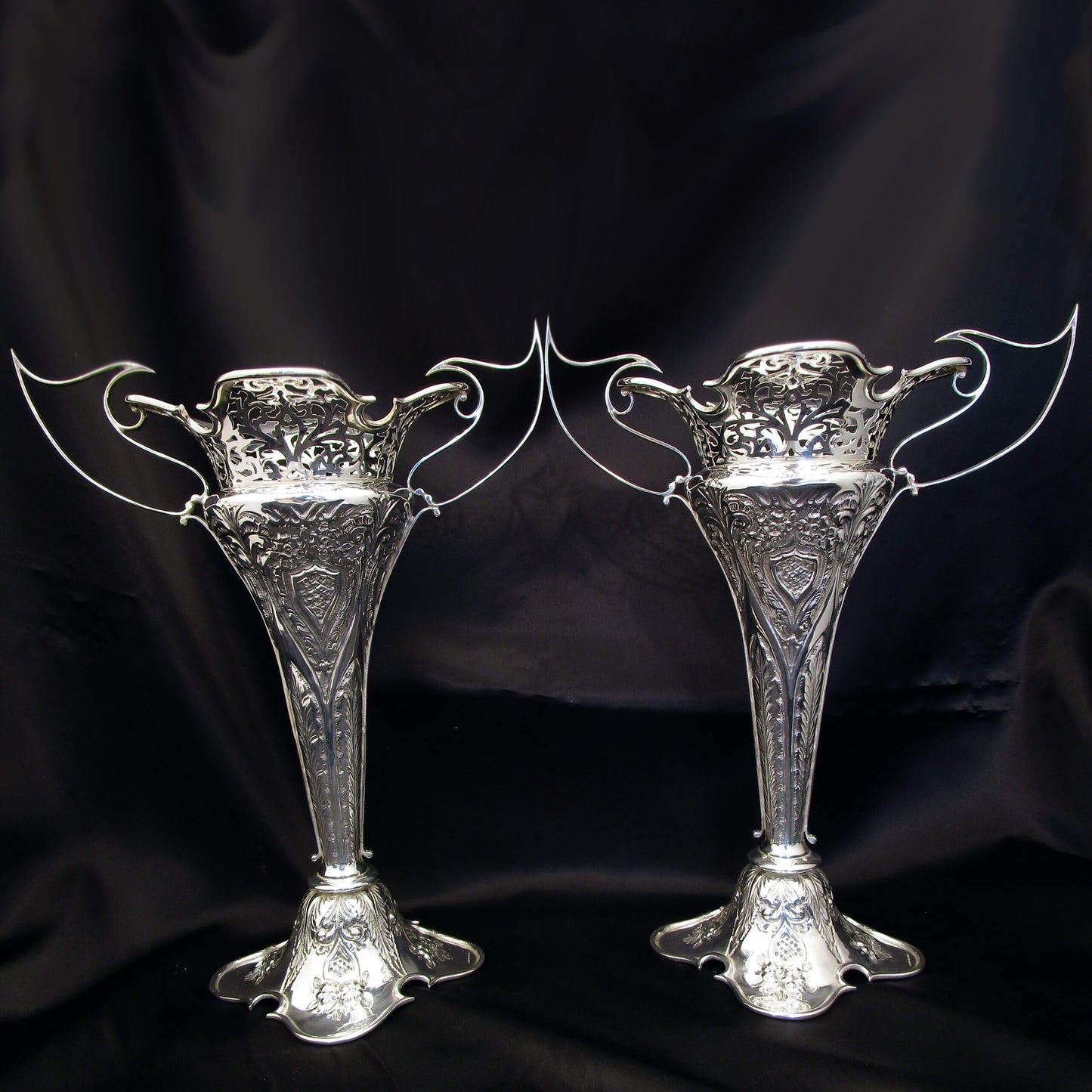 A pair of large sterling silver pierced and embossed vases by Walker & Hall.