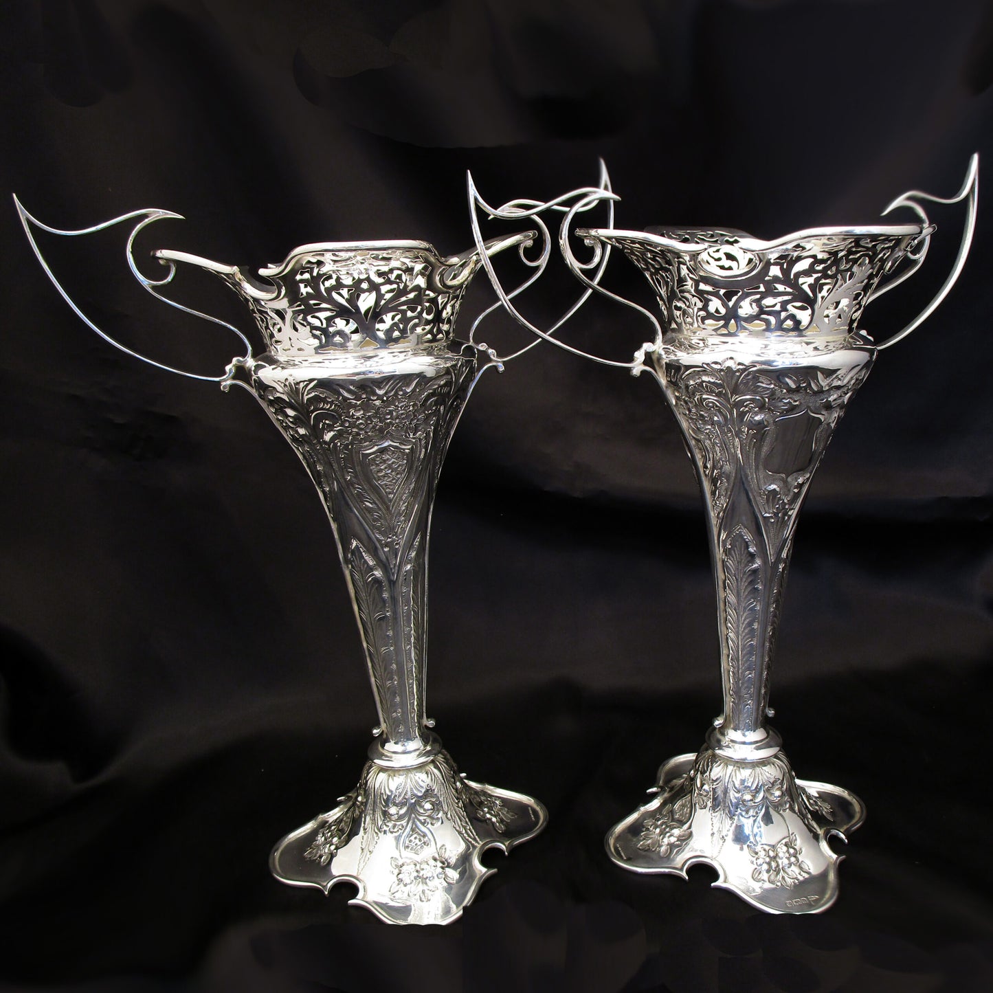 A pair of large sterling silver pierced and embossed vases by Walker & Hall.