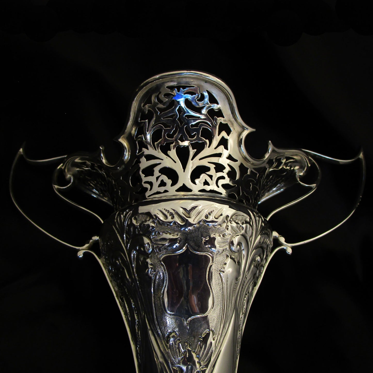A pair of large sterling silver pierced and embossed vases by Walker & Hall.