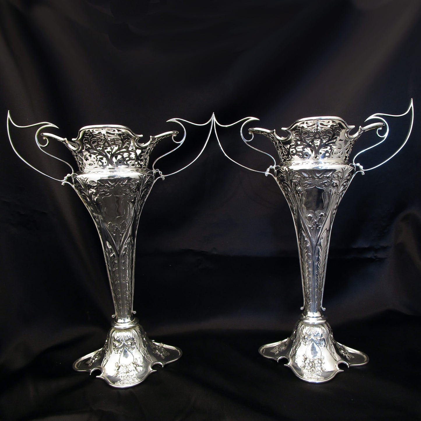 A pair of large sterling silver pierced and embossed vases by Walker & Hall.