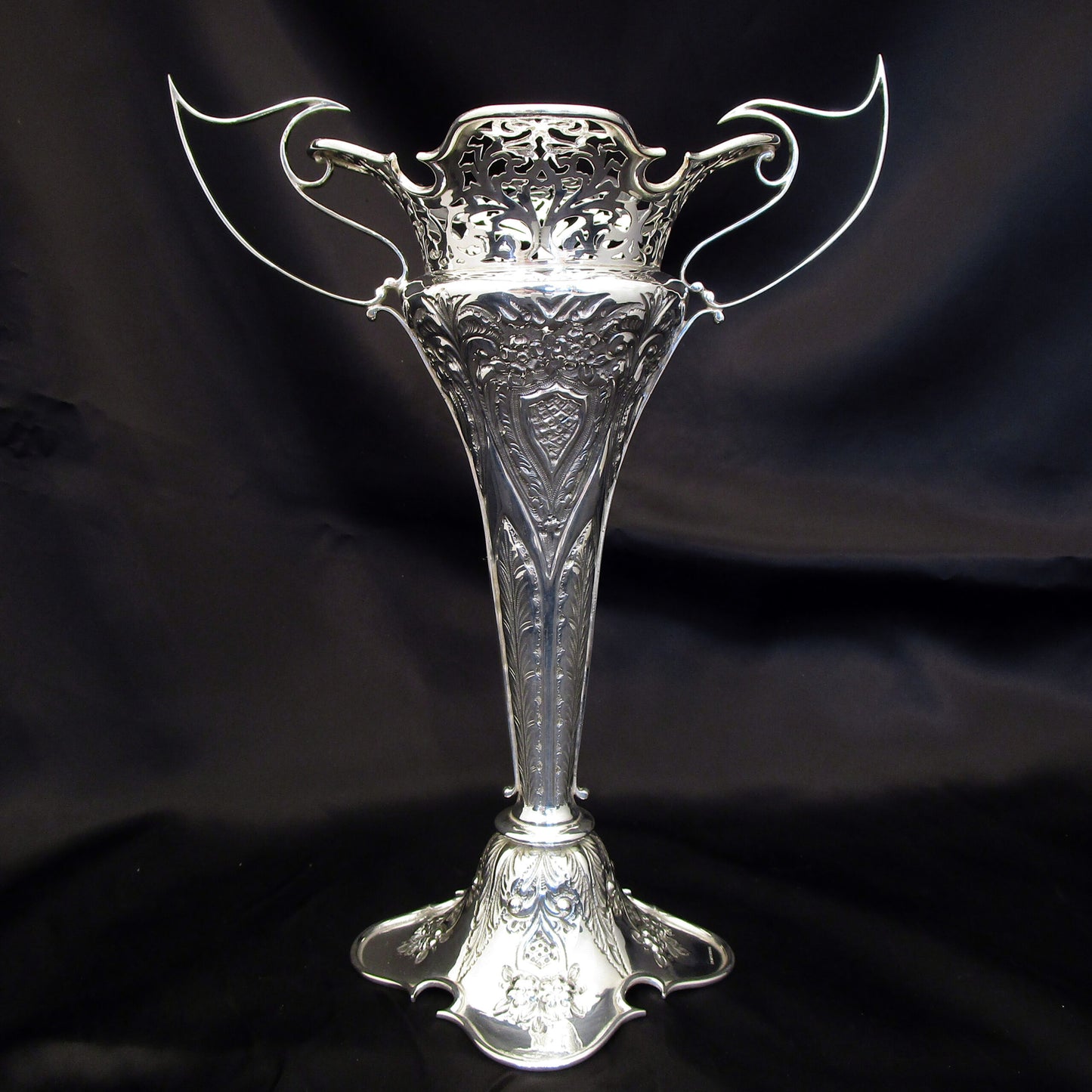 A pair of large sterling silver pierced and embossed vases by Walker & Hall.
