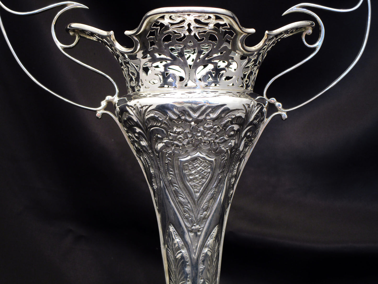 A pair of large sterling silver pierced and embossed vases by Walker & Hall.