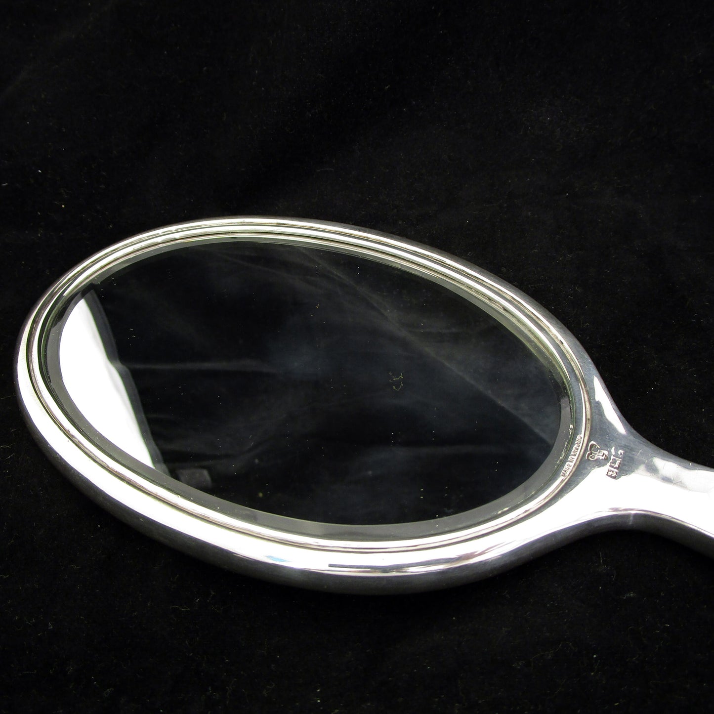 A sterling silver and enamel hand mirror.