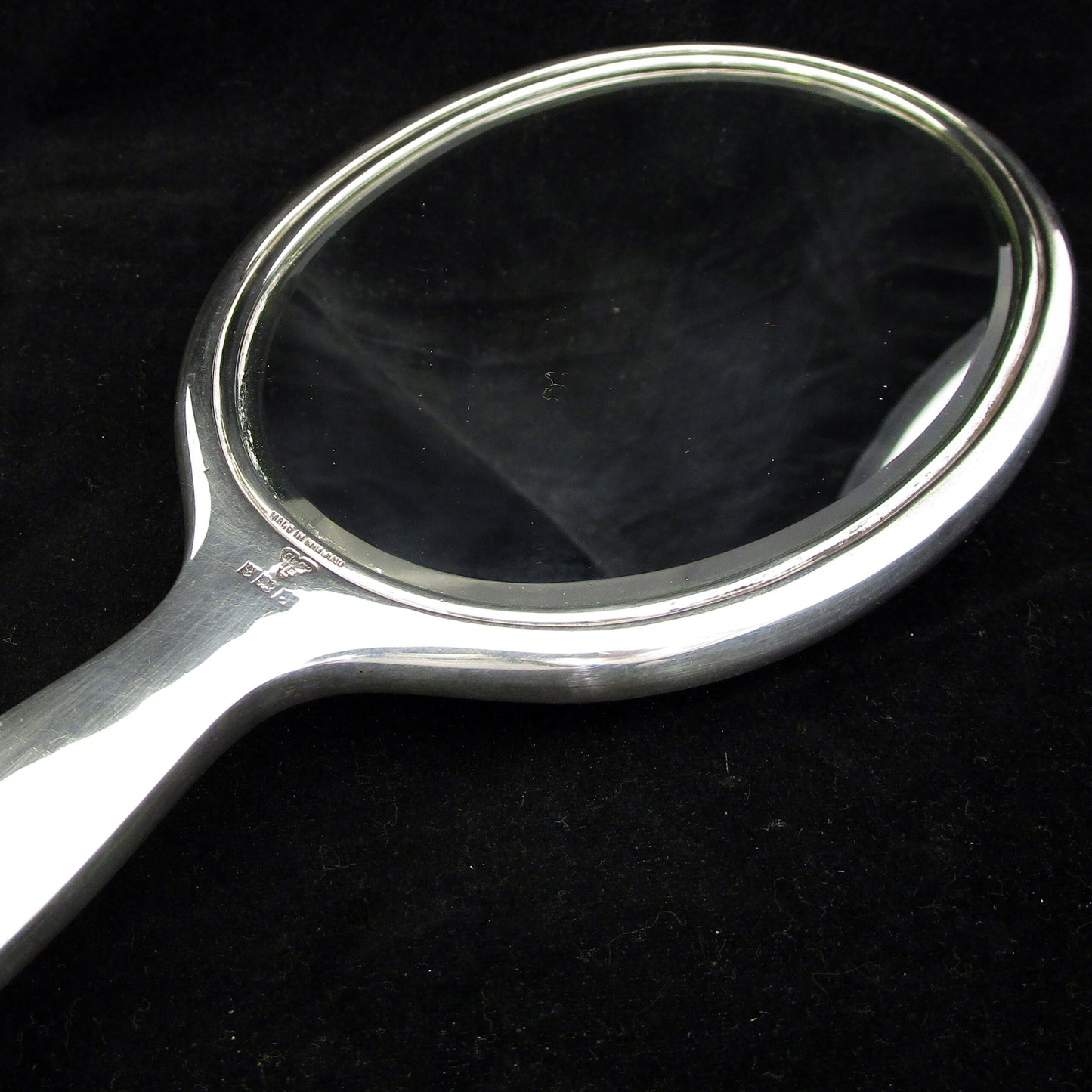 A sterling silver and enamel hand mirror.