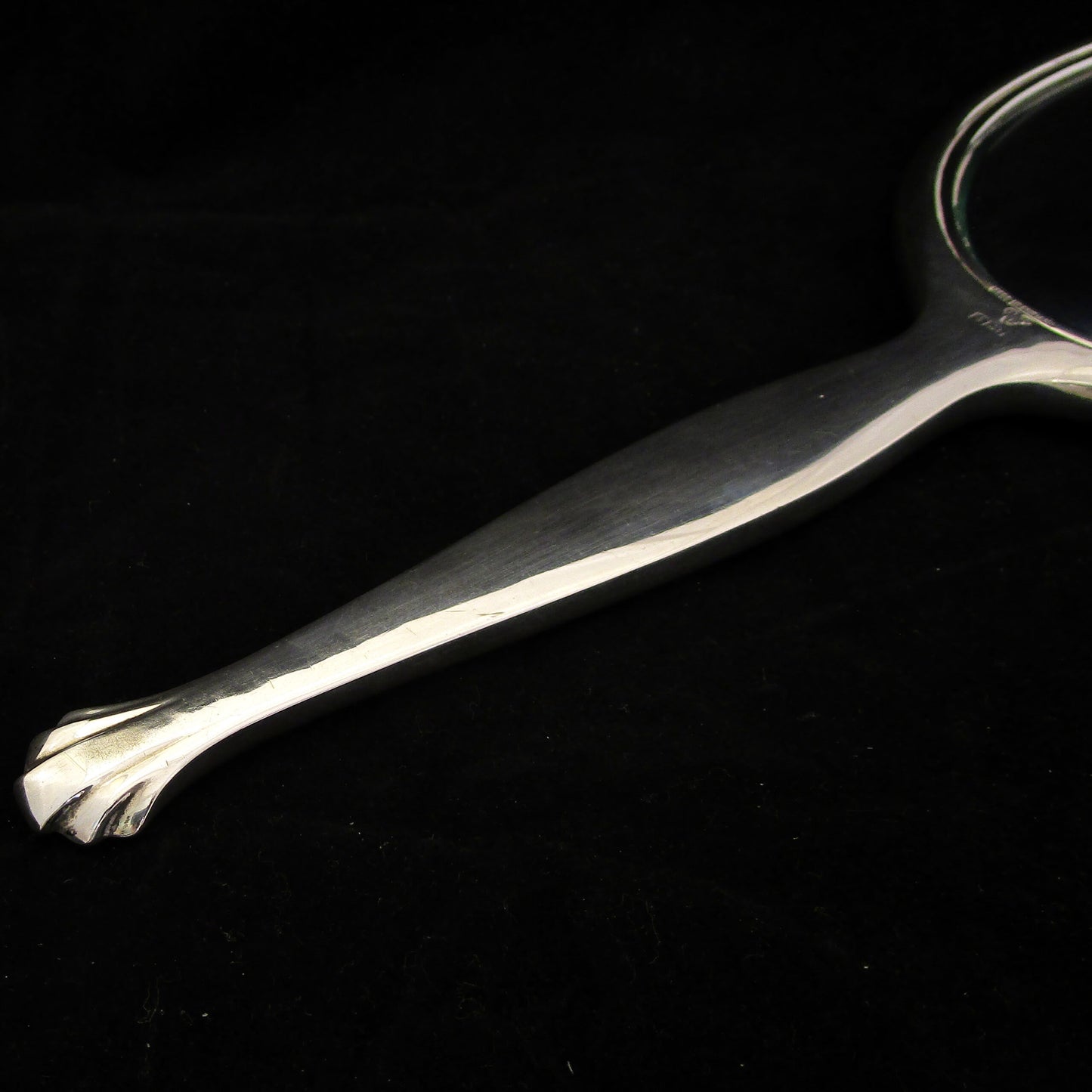 A sterling silver and enamel hand mirror.