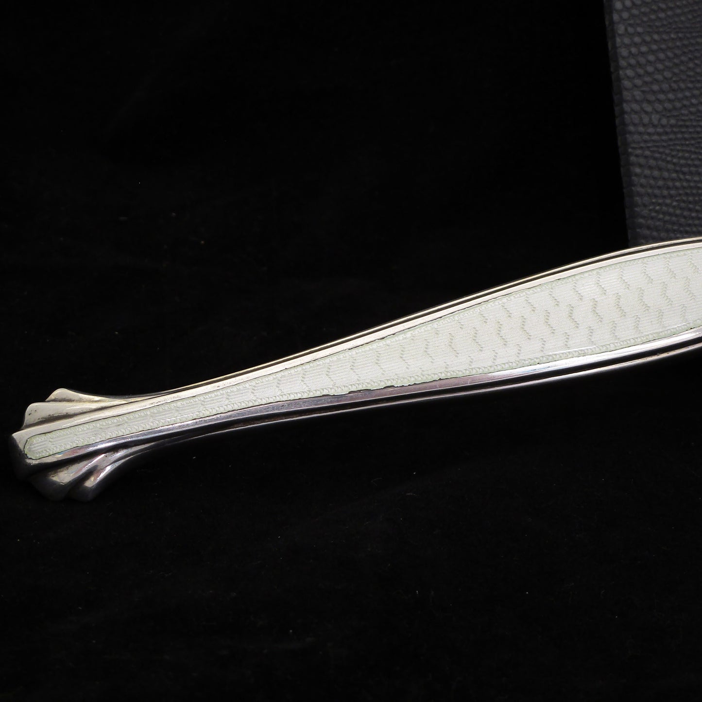 A sterling silver and enamel hand mirror.