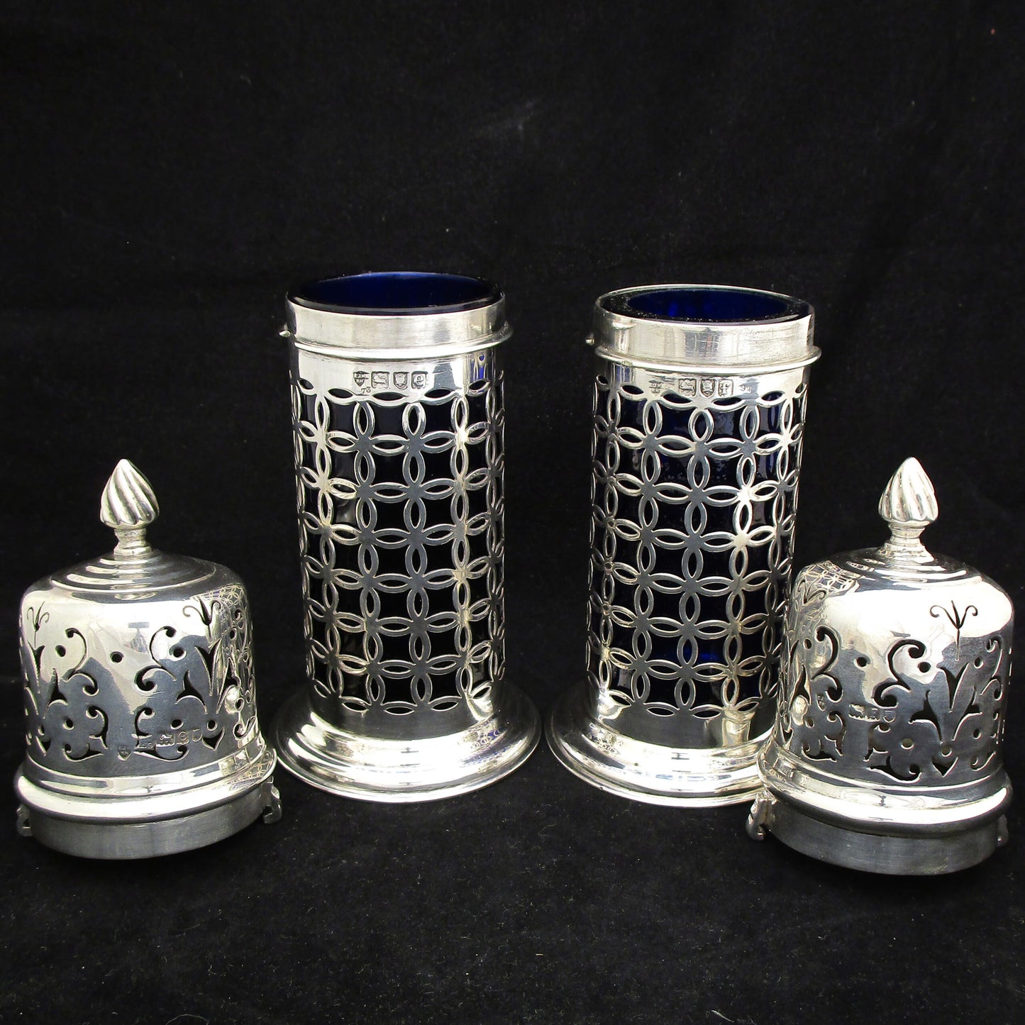 A rare pair of silver sugar shakers with blue liners.