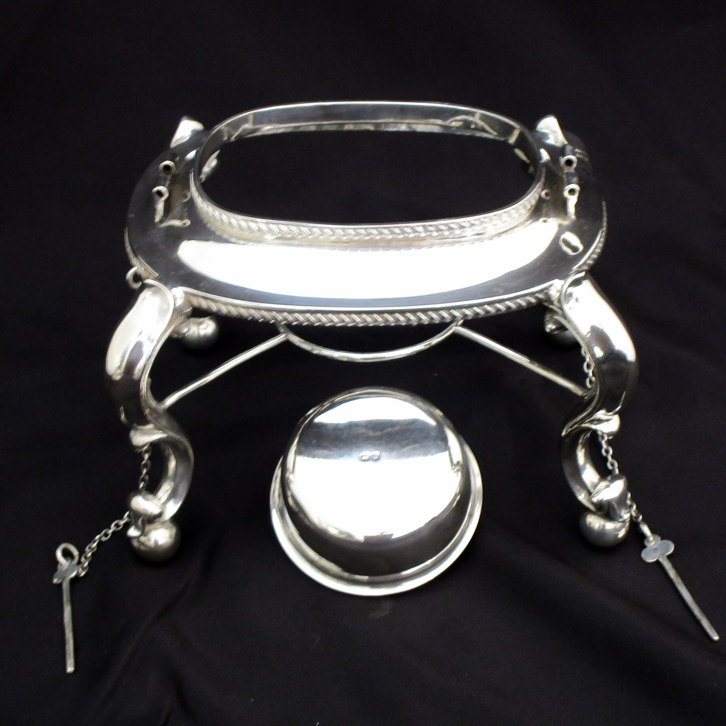 A quality sterling silver kettle on a stand.