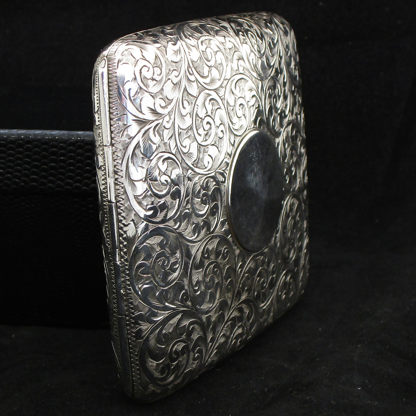 Chased silver cigarette case.