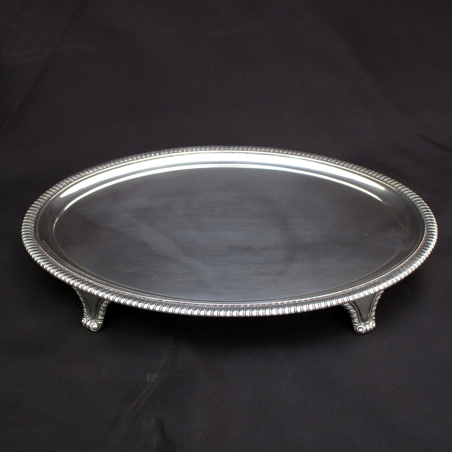 A Georgian oval gadrooned border sterling silver salva / drinks tray.