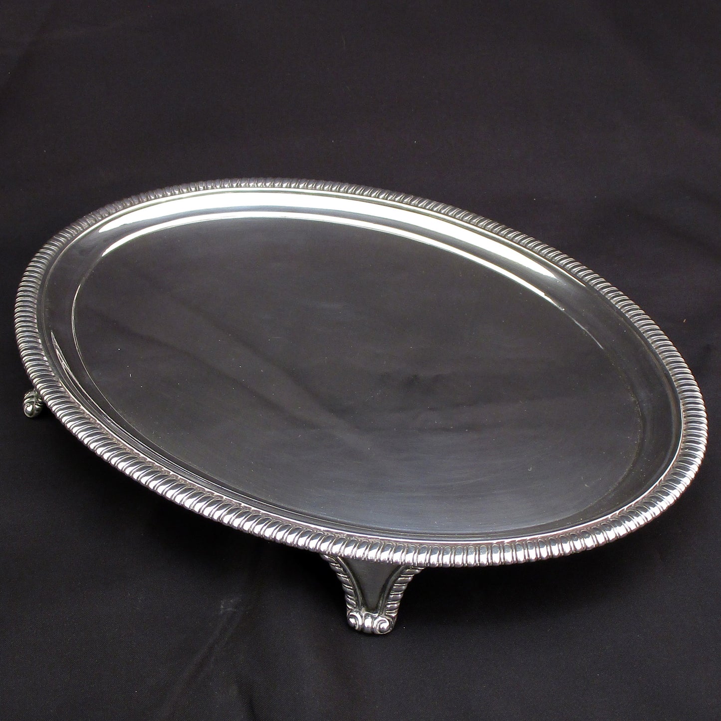 A Georgian oval gadrooned border sterling silver salva / drinks tray.