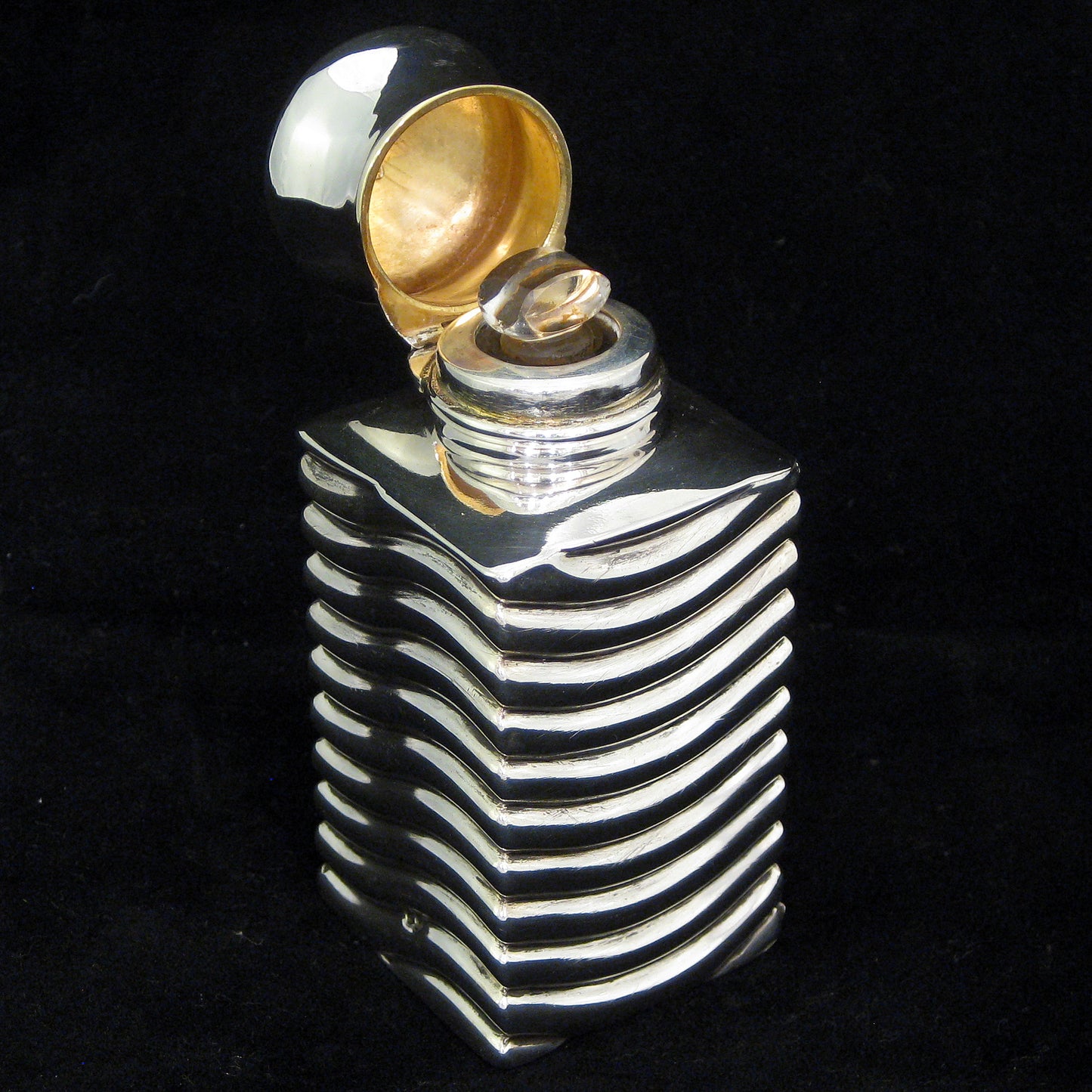 A rare unusually shaped silver perfume bottle