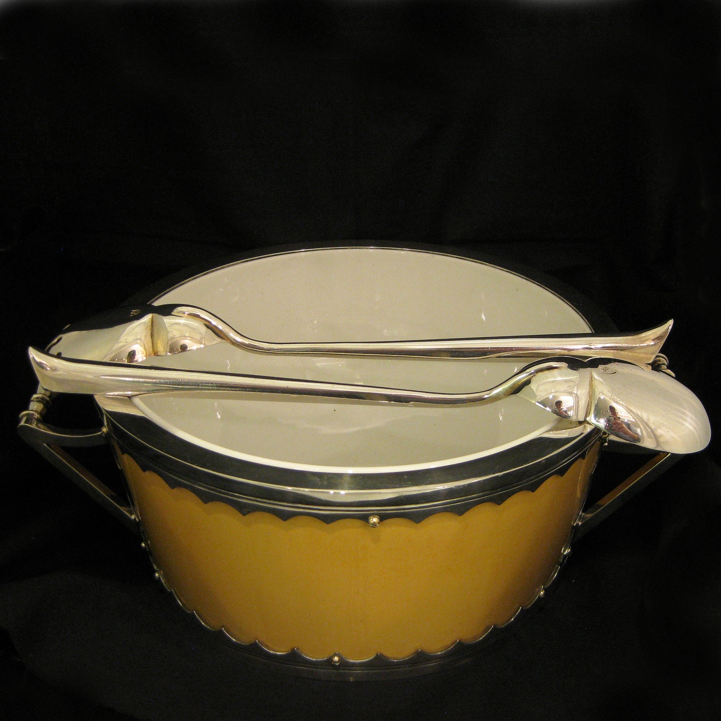 A impressive and unique salad bowl with servers.