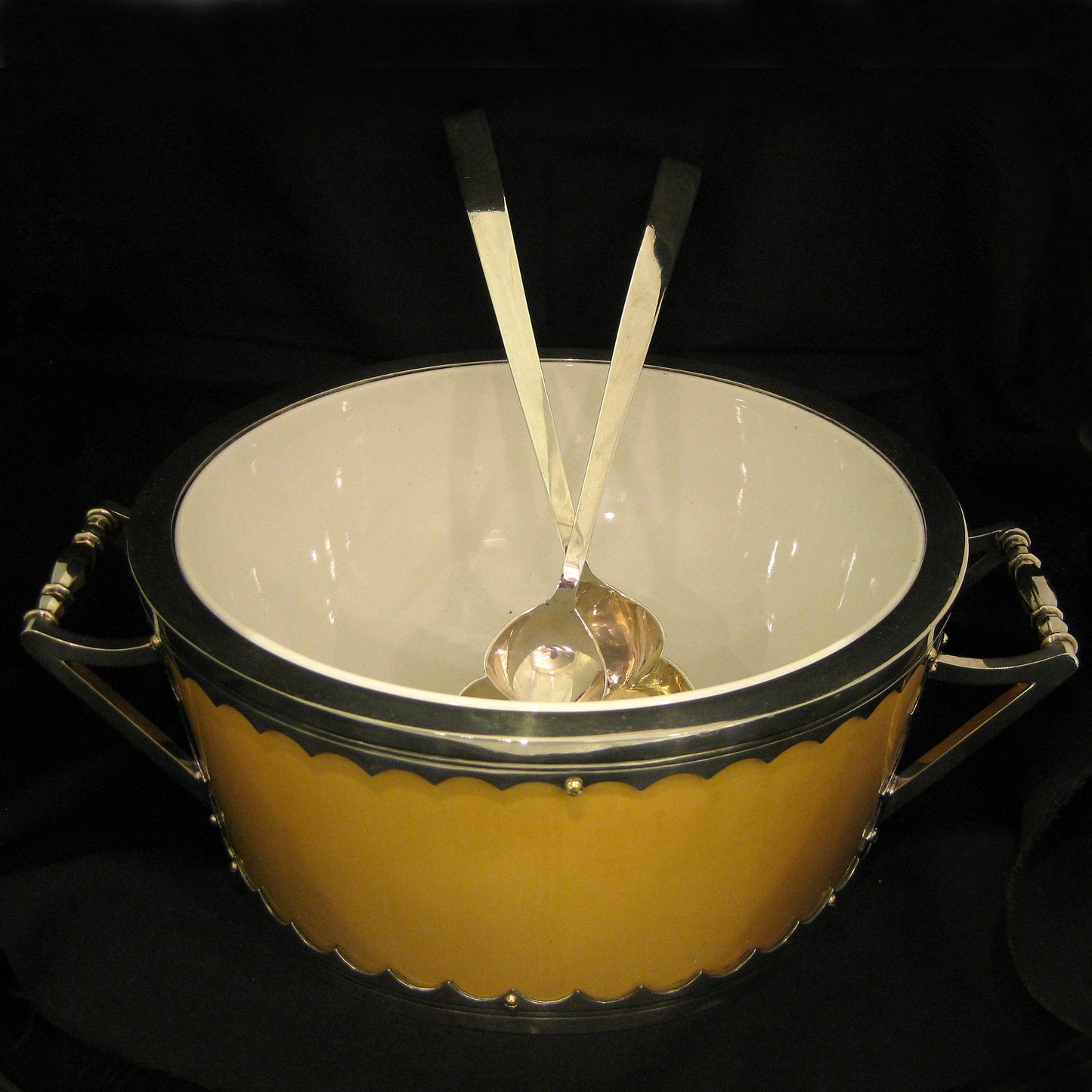 A impressive and unique salad bowl with servers.