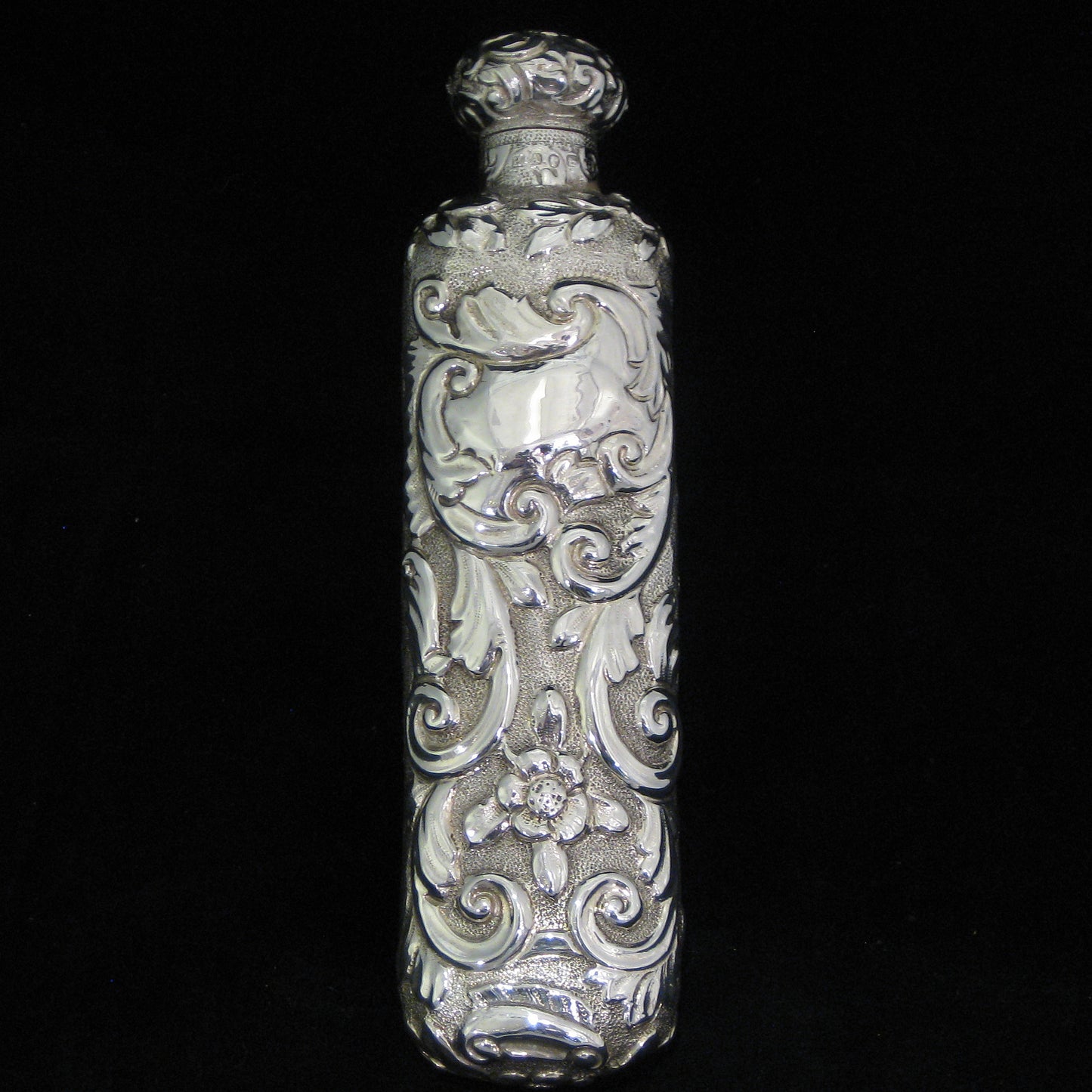 Highly decorative sterling silver perfume bottle.