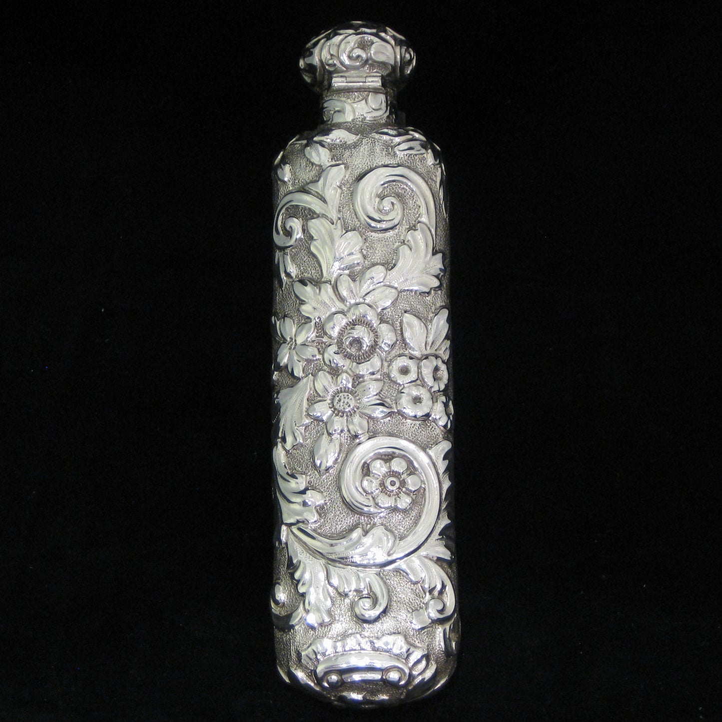 Highly decorative sterling silver perfume bottle.