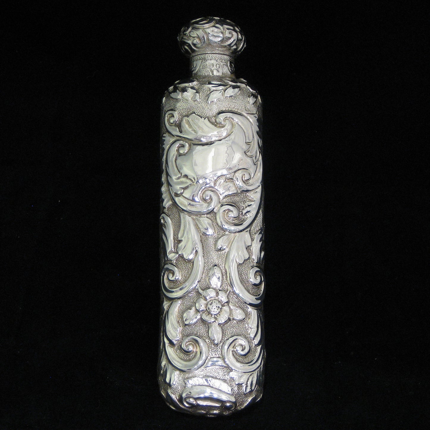 Highly decorative sterling silver perfume bottle.