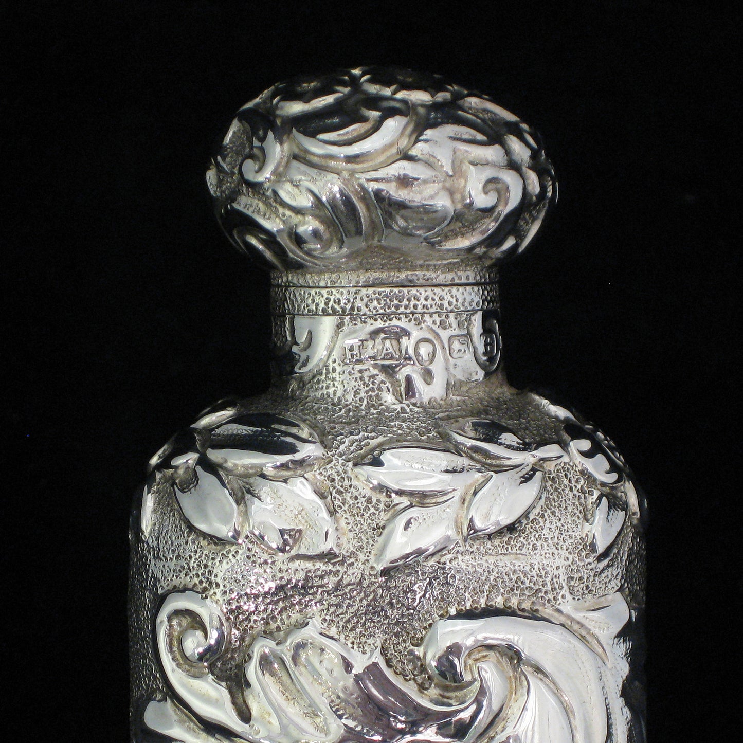 Highly decorative sterling silver perfume bottle.