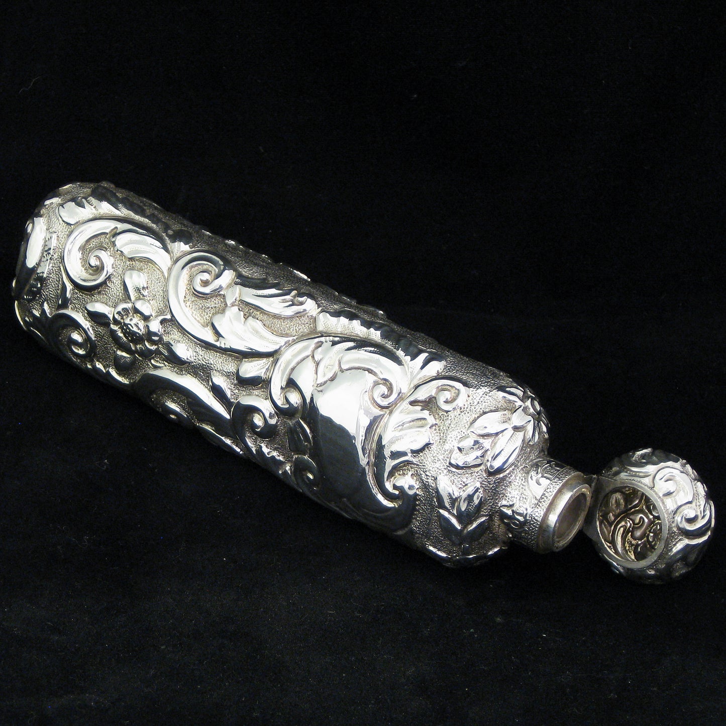 Highly decorative sterling silver perfume bottle.