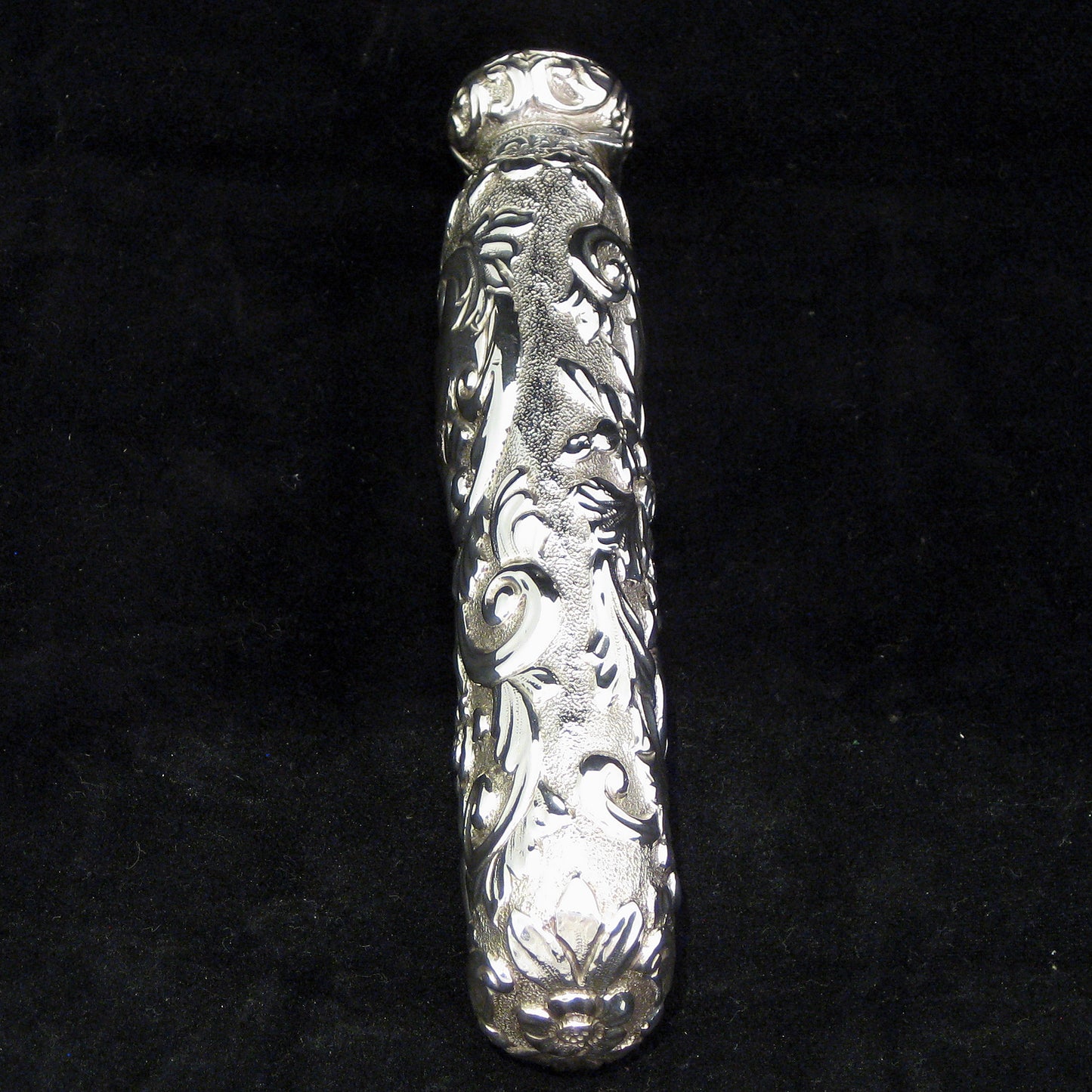 Highly decorative sterling silver perfume bottle.