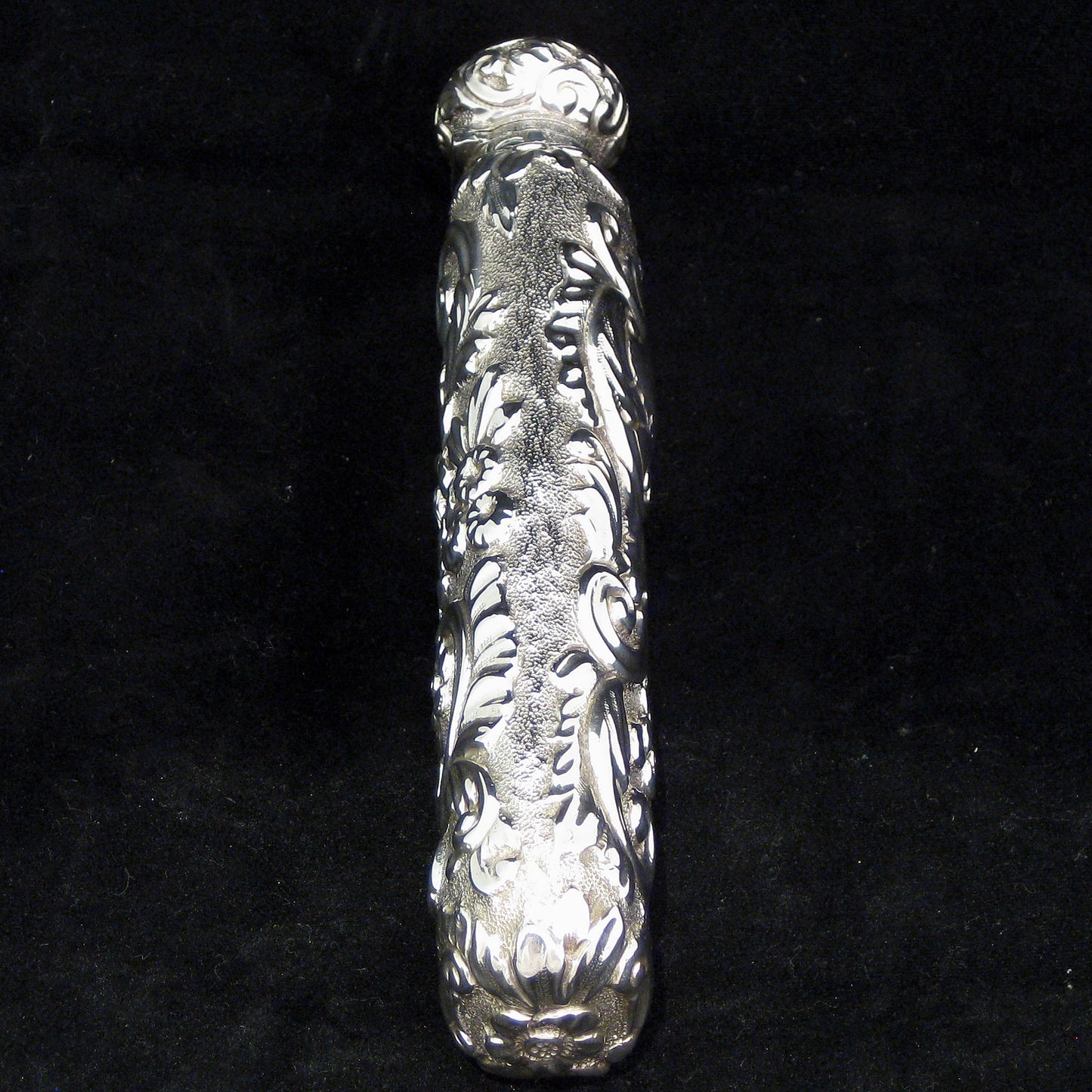 Highly decorative sterling silver perfume bottle.