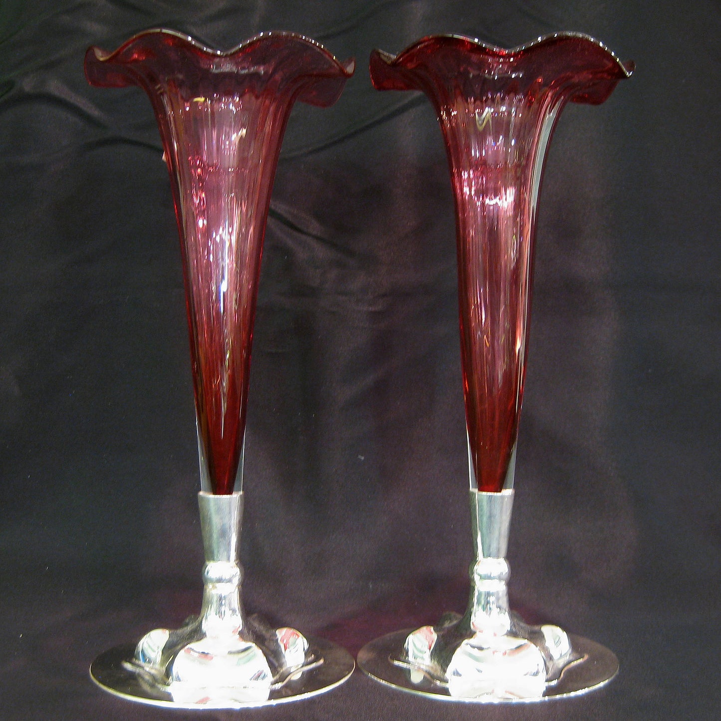 A pair of cranberry bud vases