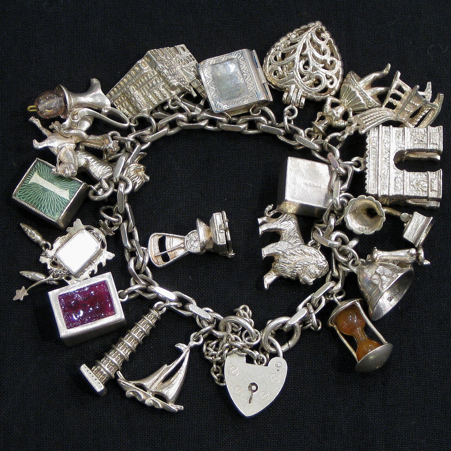 Silver charm bracelet with assorted charms.