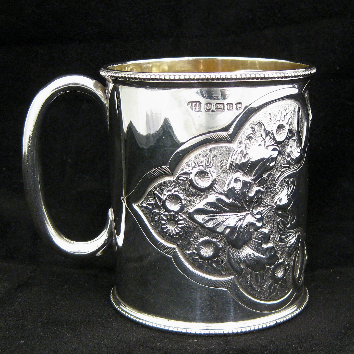 A fine quality silver embossed mug.
