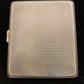 Antique sterling cigarette case with enamel shield