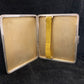 Antique sterling cigarette case with enamel shield